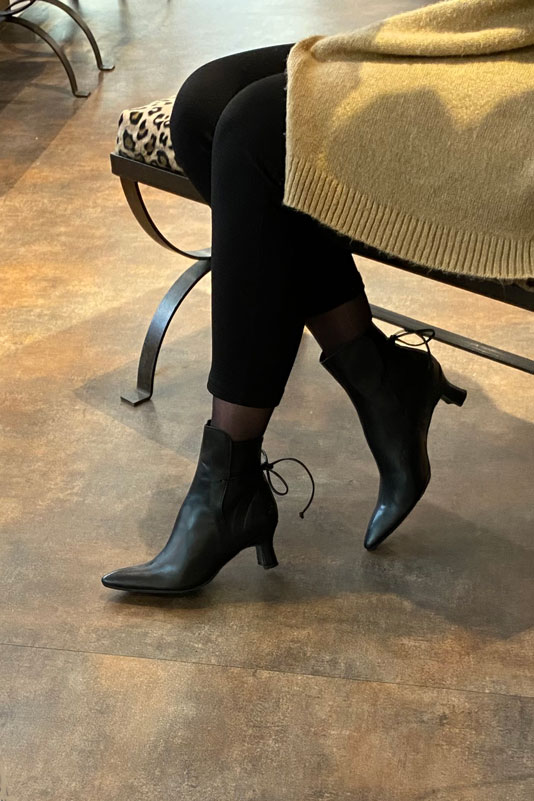 Satin black women's ankle boots with laces at the back. Tapered toe. Medium spool heels. Worn view - Florence KOOIJMAN